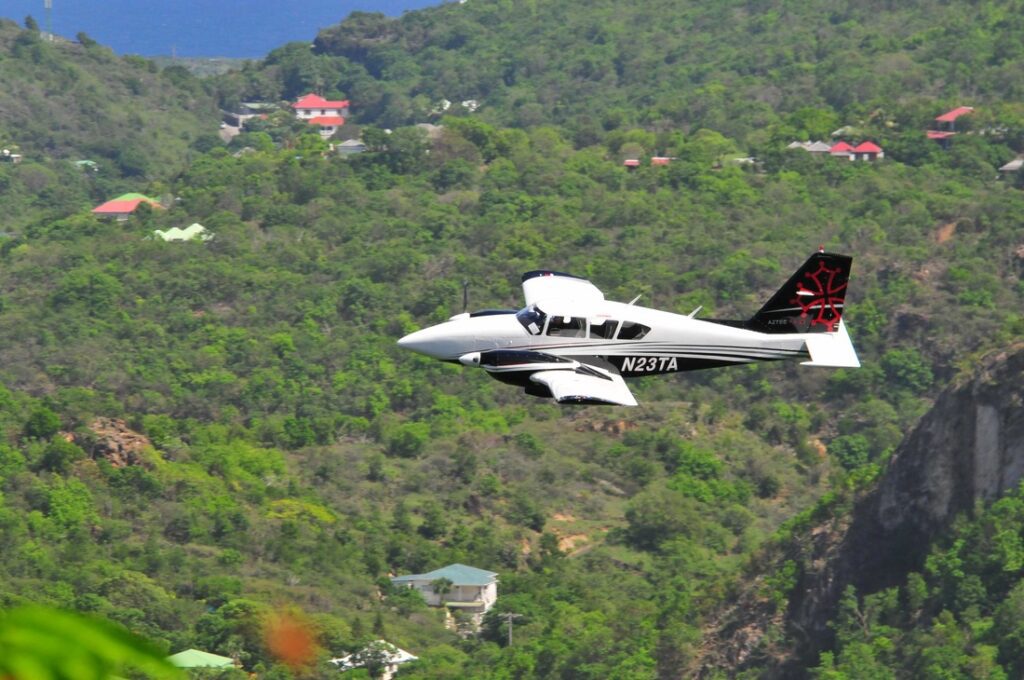 Aztec aircraft flying over an island