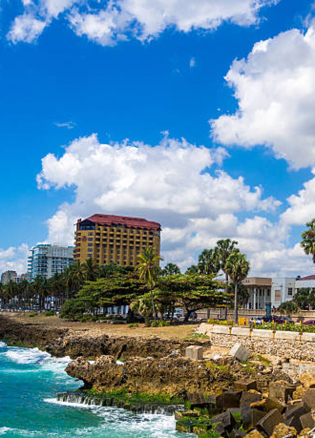 Santo Domingo, Dominican Republic - February 23, 2013: View of a waterfront walkway with people that can be seen in the distance along the waterfront walkway on a clear day with waves breaking on the shore line in an are known as the Malecon.